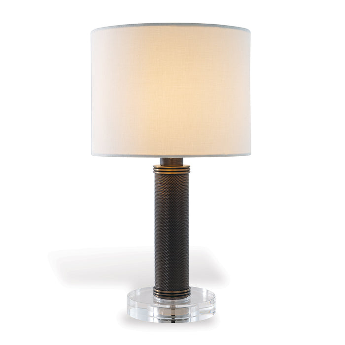 Table lamp with a textured black base and clear acrylic stand on a white background