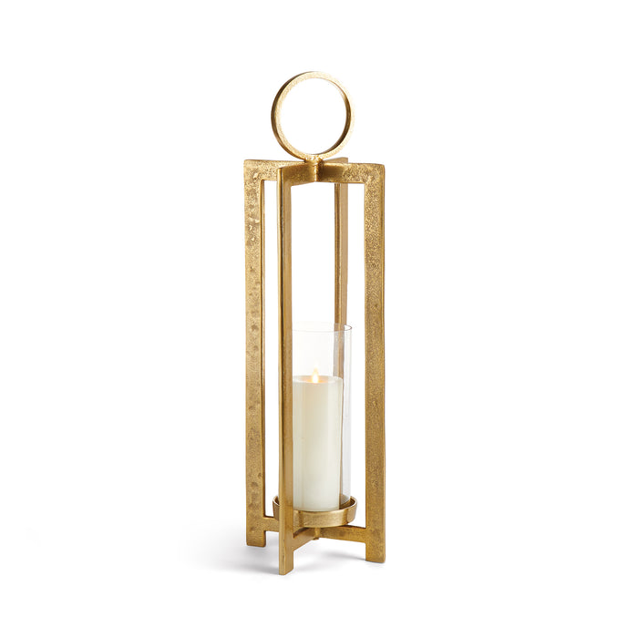 A gold-colored metal lantern with a glass candle holder on top and a large circular handle.