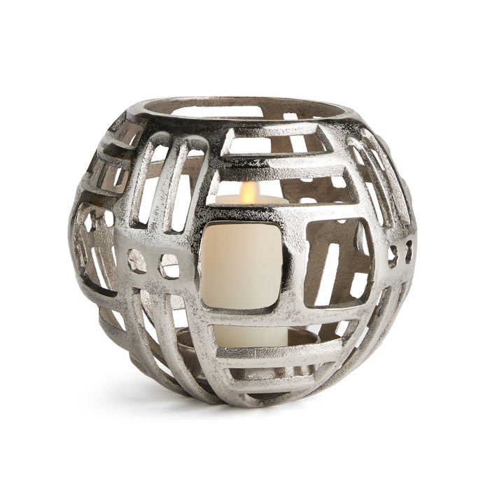 A round aluminum candle holder with geometric cut-outs and a central square opening for the candle.
