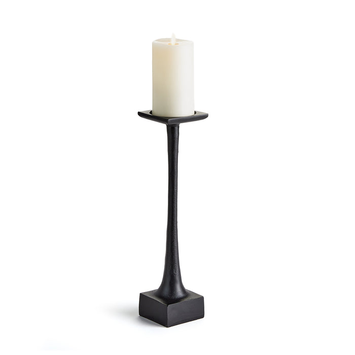 A black candle stand with a weighted base and a tall slender body, designed to hold a candle.