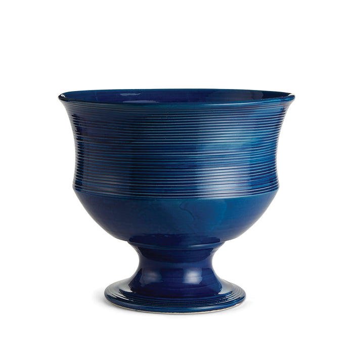Tall cobalt blue decorative bowl with horizontal ribbed texture, pedestal base, glossy glaze on white background.