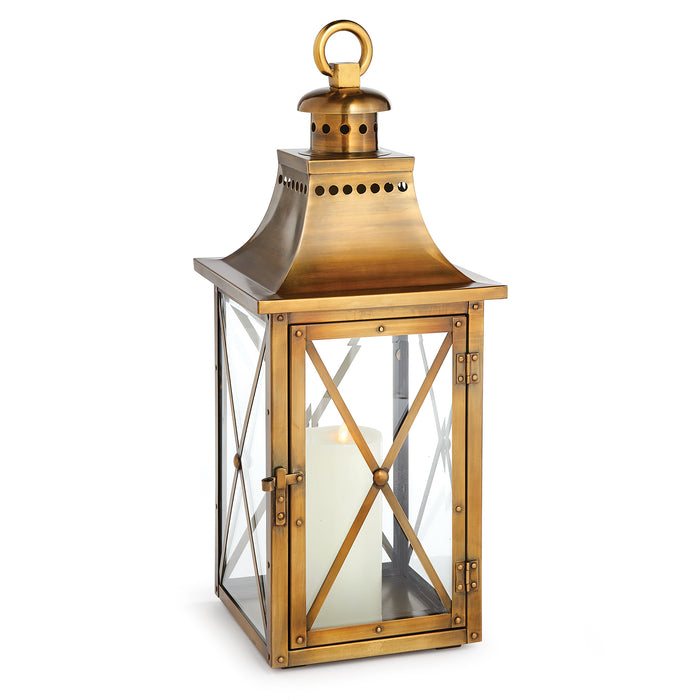 Antique brass lantern with a glass enclosure and a top handle for hanging