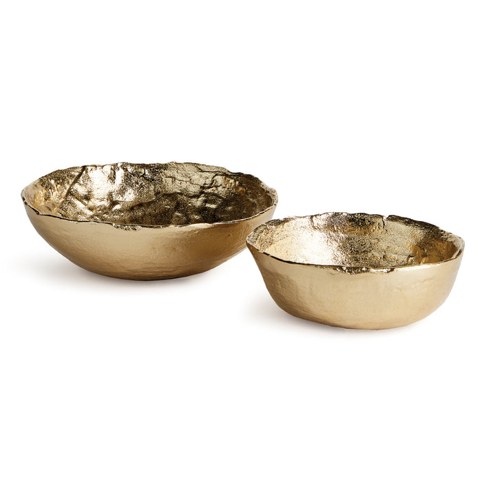 Two irregular gold bowls, textured interior and smooth exterior, set against a white background.