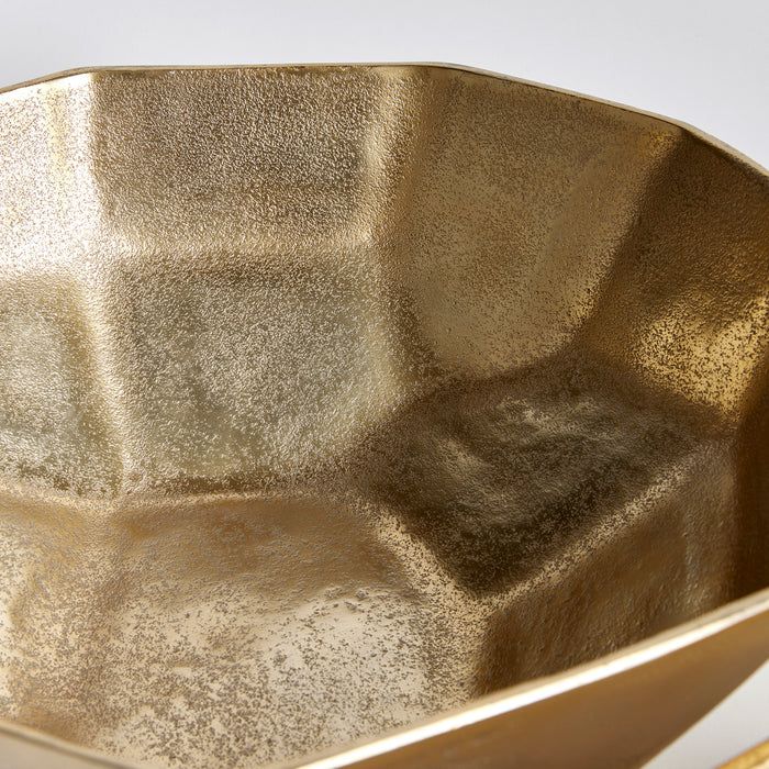Gold-toned, textured ceramic serving bowl with irregular geometric interior; two bowls set against a light gray backdrop.