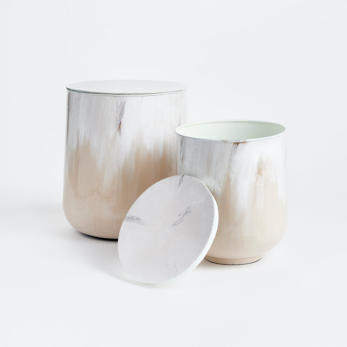 Set of two cylindrical ceramic storage canisters with white-to-beige marbled glaze, one with lid and one open, rounded
