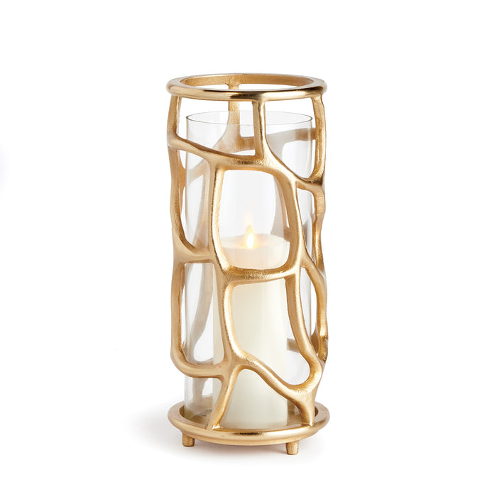 A matte gold finish hurricane-shaped candle holder with a meandering geometric design and a glass cylinder containing a candle.