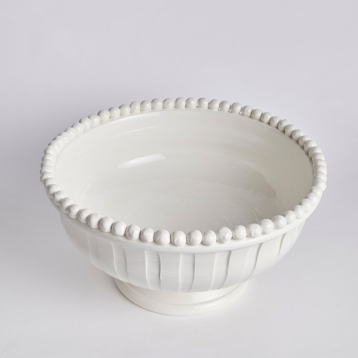 White decorative footed bowl with beaded rim, ceramic finish, shallow curved sides on a pedestal base.