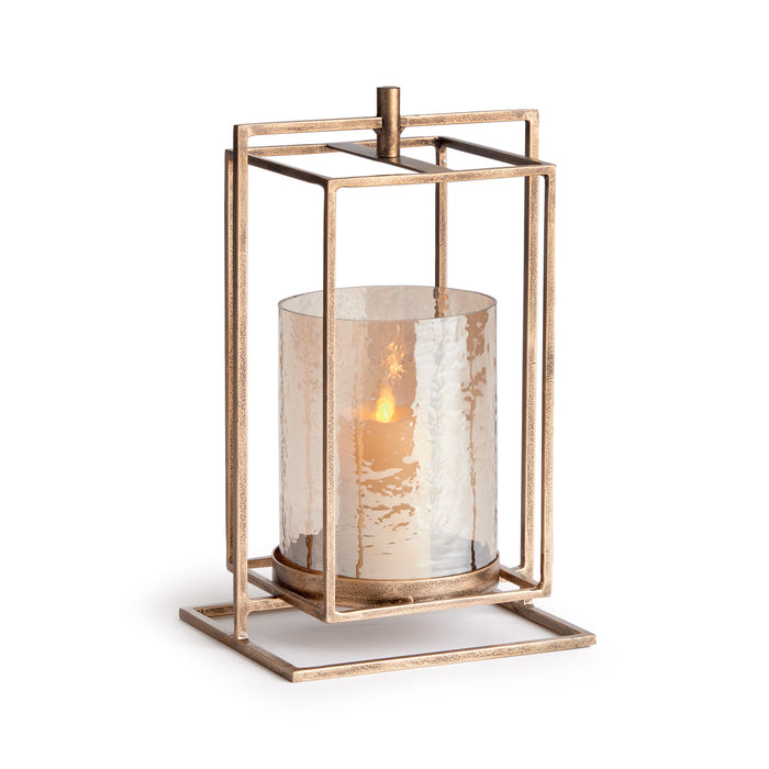 A small hurricane-style candle holder with a warm antique gold finish and hammered glass.