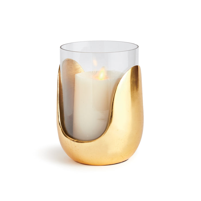 A medium-sized hurricane-style candle holder with a hand blown glass top in a warm champagne color, sliding into a cast aluminum abstract base.