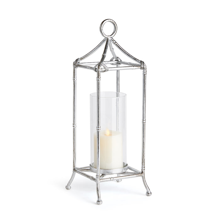 A contemporary silver lantern with a glass cylinder, designed for holding a candle, with an antique silver finish.