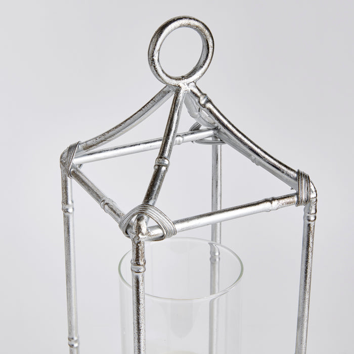 Small silver metal lantern frame with a circular loop top and glass cylinder candle holder inside, rustic wrapped wire