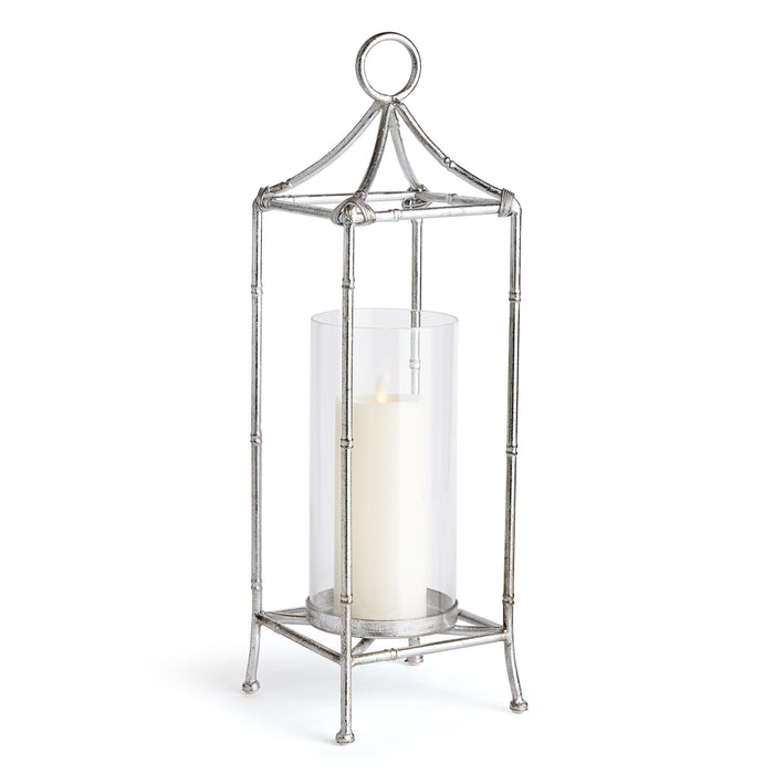 A contemporary silver lantern with a glass cylinder, designed for holding a candle.