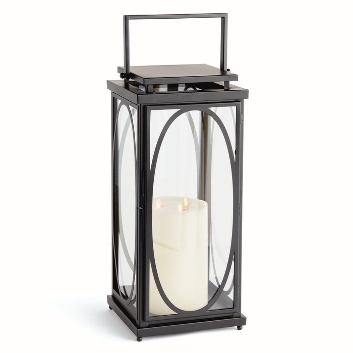 A black lantern with an oval frame design, featuring a open top and a wide square base, holding a candle.