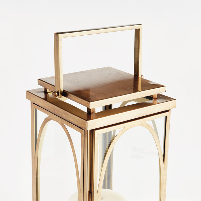 Copper-toned metal lantern with glass panes, arched cutouts, and a removable top handle.