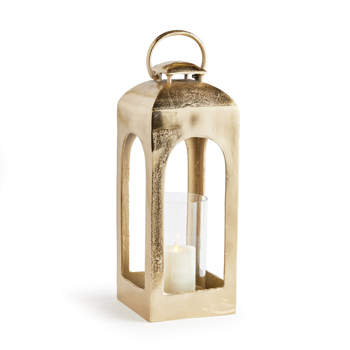 A champagne gold finish lantern with a glass candle holder and a lid with a handle on top.