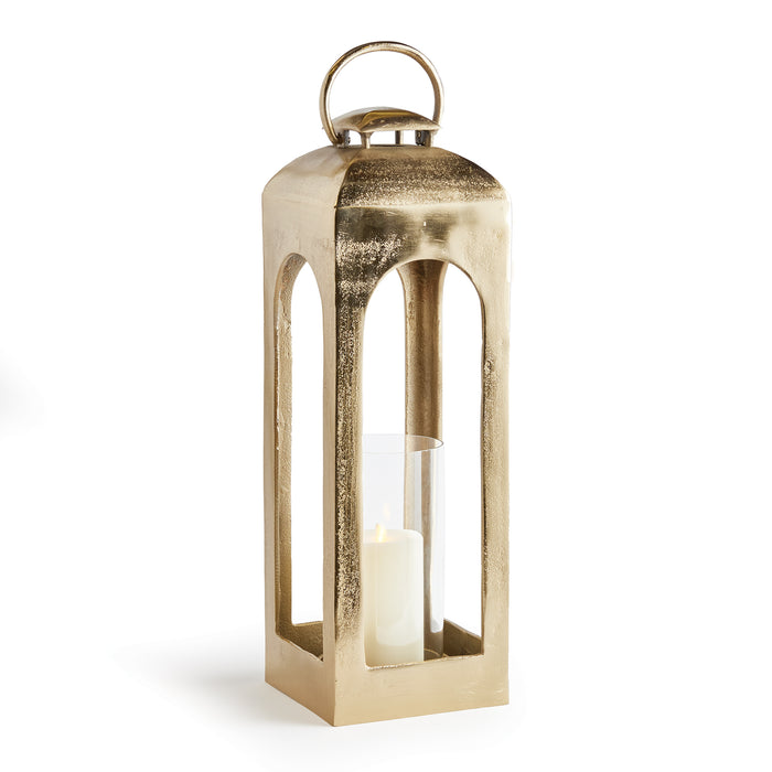 A champagne gold finish lantern with a glass candle holder and a metal top.
