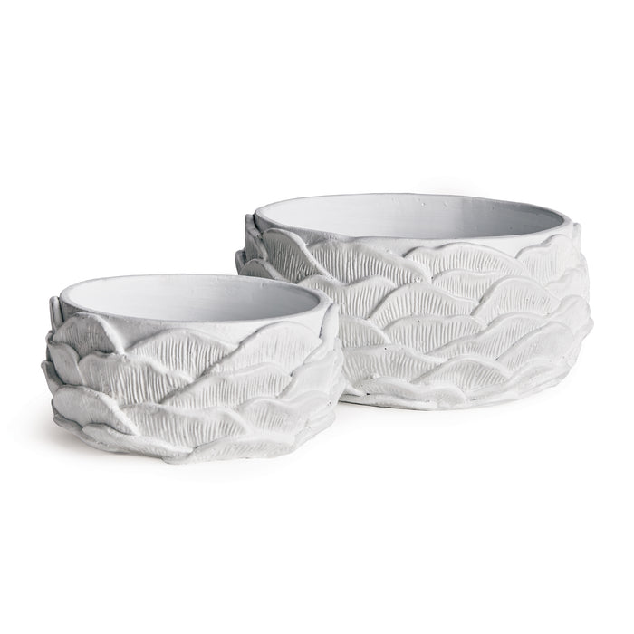 Two white ceramic pots in a nested scallop shell pattern with textured overlapping leaves on a white background
