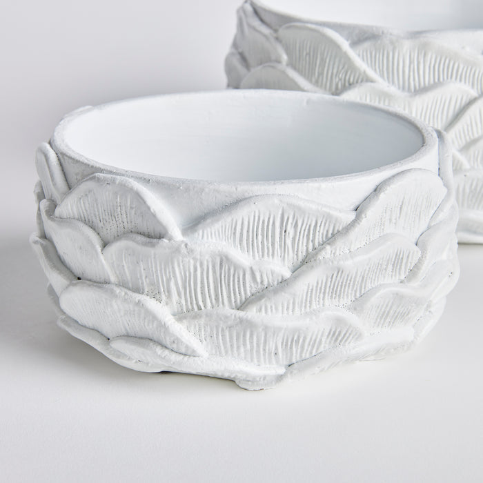 White ceramic bowls with textured leaf-like exterior, smooth interior, set of 2, on white surface with soft background.