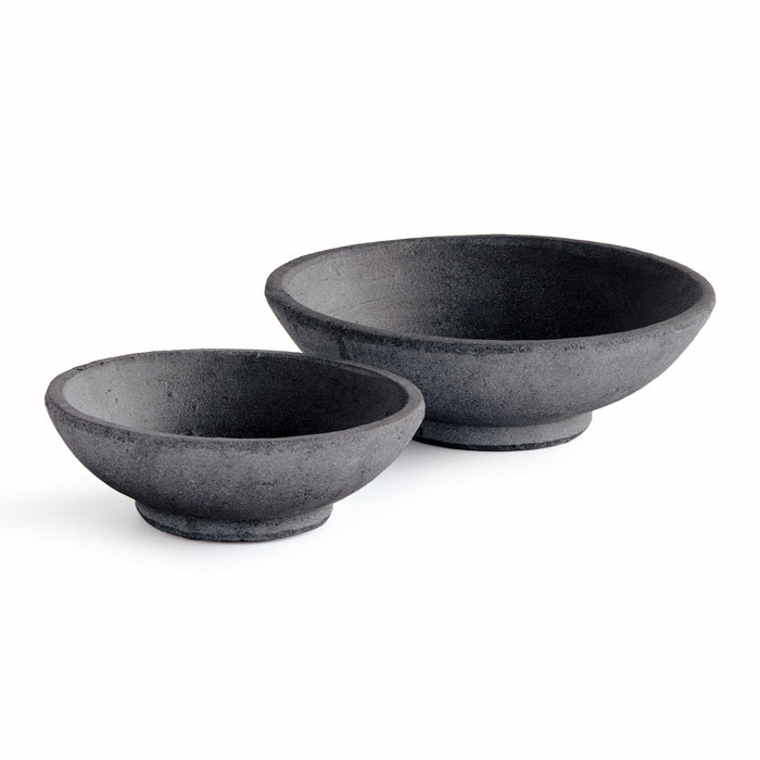 Dark gray textured ceramic bowls, set of two, shallow with wide rims, placed on white background.
