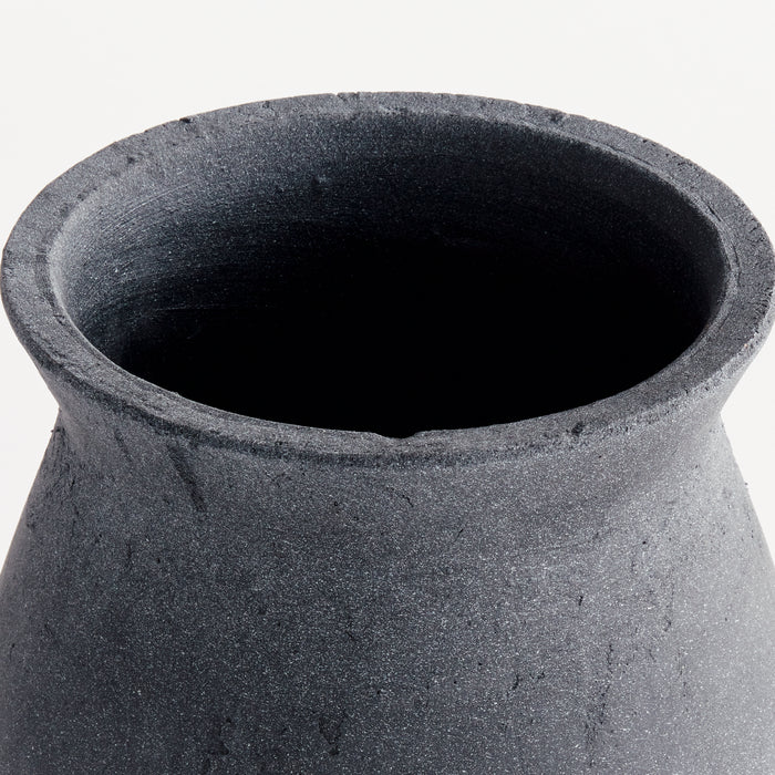 Dark grey speckled ceramic vase with wide mouth, matte finish, and rough texture against light background.