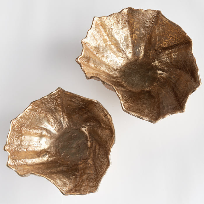 Two gold-toned decorative bowls with irregular lobed edges and a hammered metallic texture on a light background.