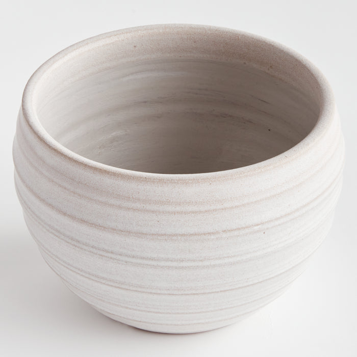 Large white ceramic pot with subtle horizontal grayish stripes, wide opening, smooth interior, rounded body, pale speckled