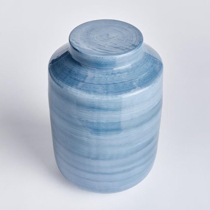 Blue glazed ceramic ginger jar with a matching lid, cylindrical body, horizontal brush-stroke bands, light to medium blue
