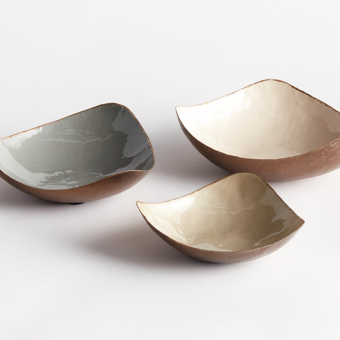Three curved bowls, exterior brown ceramic, glossy interior in gray, cream, and beige, set on white background.