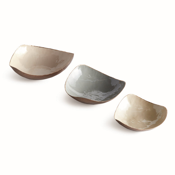 Set of three decorative bowls with irregular square shapes in neutral glaze colors (tan, gray, and beige) and brown bases on