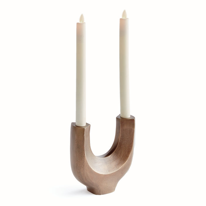 A modern sculpture designed to hold two tapers, made of aluminum with a wooden base.