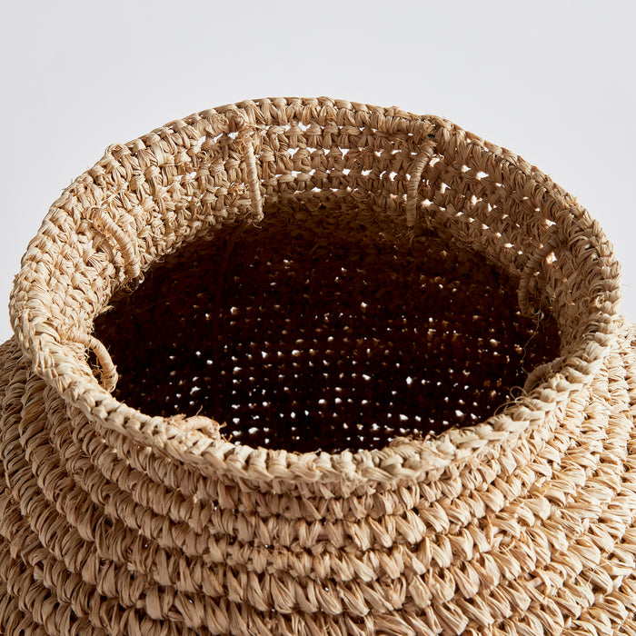 Large woven straw vase with natural beige fibers and a dark inner lining/lining visible at the rim, round basket weave.