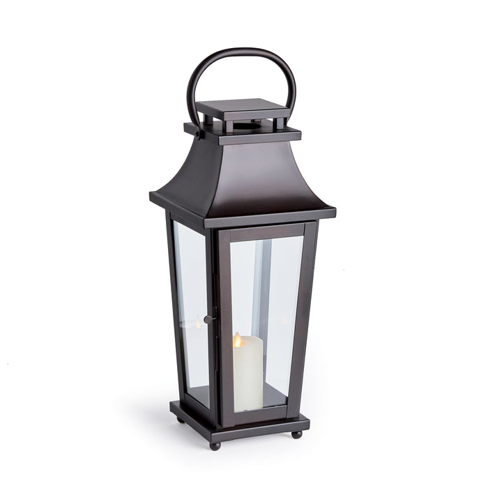 Maurice Outdoor Lantern Small in black metal with glass panels and a candle inside, circular handle top, on a square base.