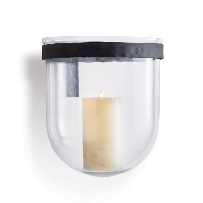 A clear blown glass wall vessel with an aged zinc band, featuring a candle inside.
