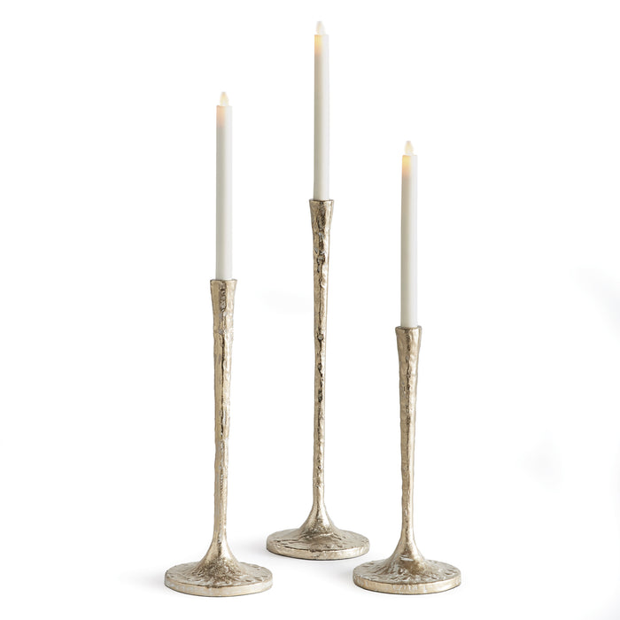 A set of three silver-colored taper candle holders with a white ash gold finish, made of aluminum and MDF, displayed against a white background.