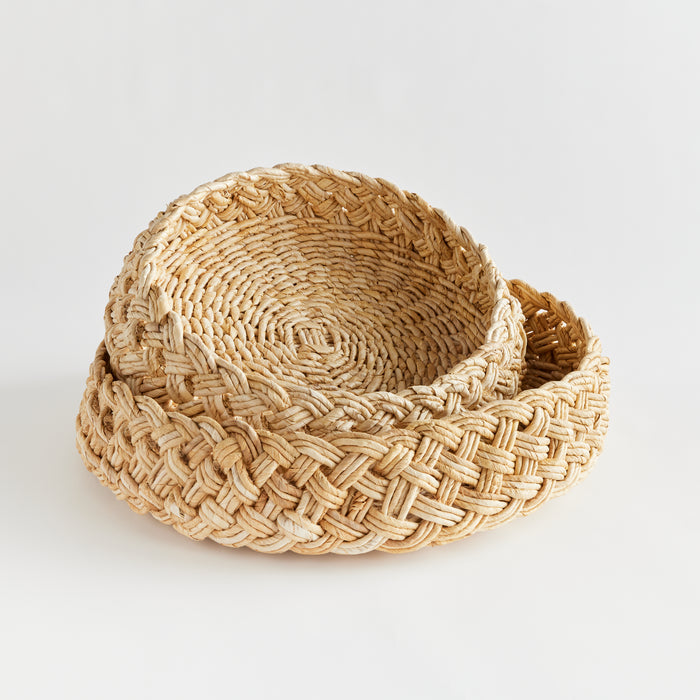 Set of two natural abaca braided baskets with thick, woven rims on a light background.