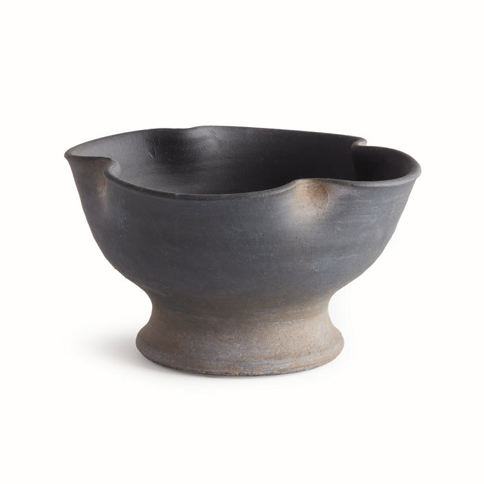 Dark charcoal ceramic bowl with a flared rim, spouted edge, and pedestal base on a light background.