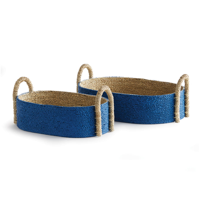 Two oval-shaped baskets with a seagrass rope handle, in a natural beige and indigo color.