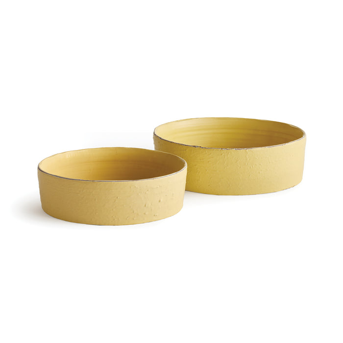 Two yellow decorative bowls, textured ceramic, shallow with smooth interior, set against white background.