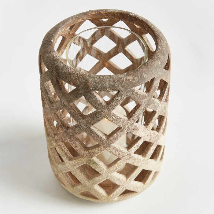 Rusty brown lattice hurricane lantern with a glass holder inside, cylindrical, textured metal with diamond cutouts, neutral
