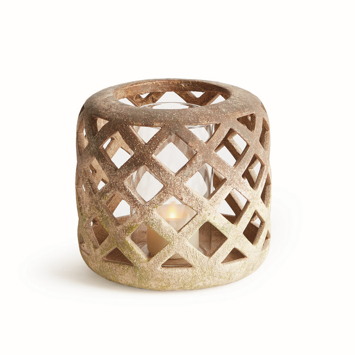 A small terracotta-colored ceramic hurricane with a geometric pattern and a glass insert, designed to hold a candle.