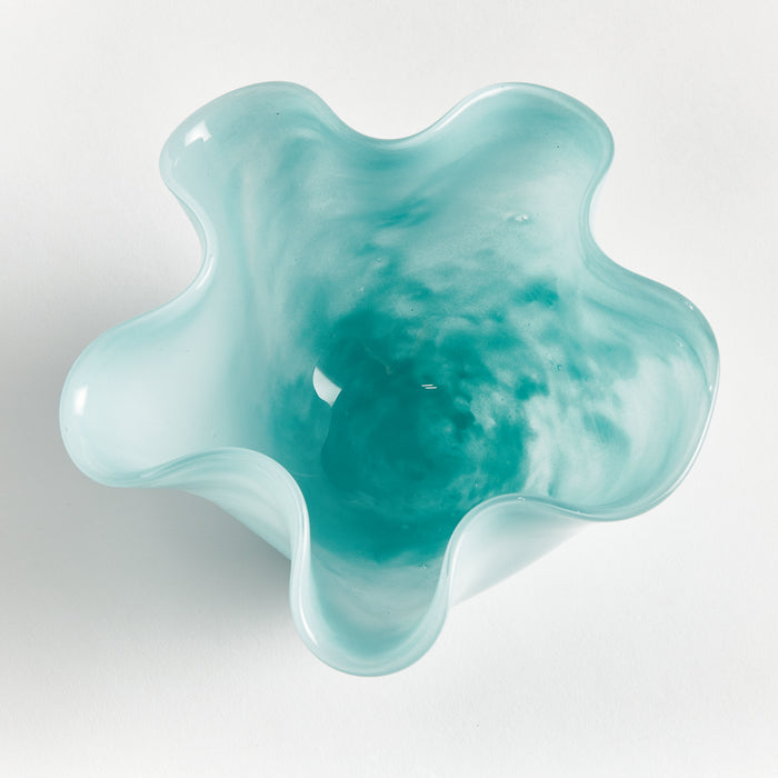 Turquoise glass bowl with a wavy, flower-like edge on a white background, smooth glossy surface, shallow interior.