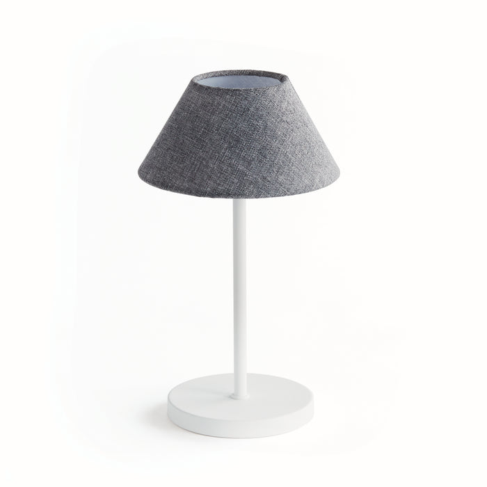 A cordless LED lamp with an empire linen shade, mounted on a white base, against a white background.