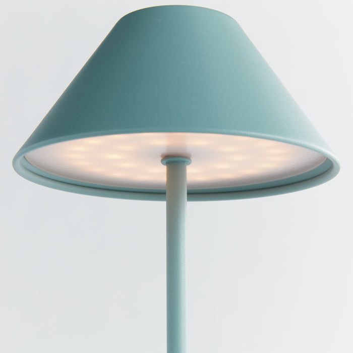 Turquoise cordless LED lamp with a conical shade atop a slim stand, illuminated bottom light, minimal background.