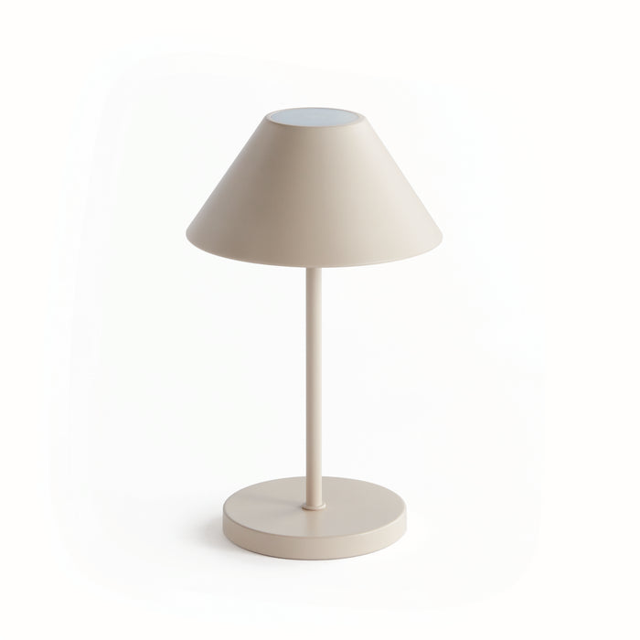 A cordless LED lamp with an empire linen shade, standing on a circular base, in a neutral color.