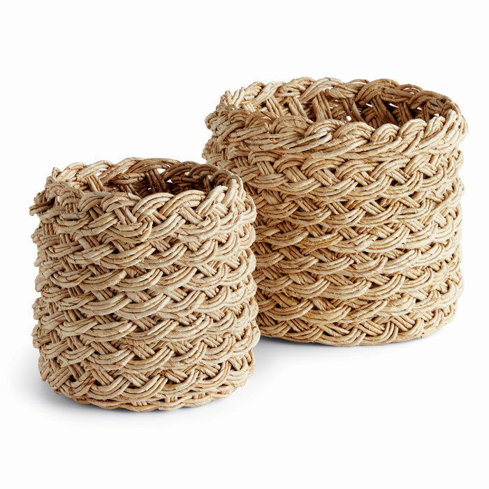 Two round, beige-colored wicker storage baskets with a French braid design.