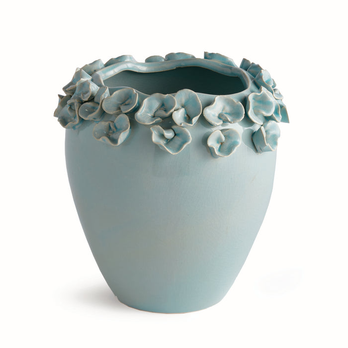 Tall pale blue vase with ruffled edge of petal-like blue accents along rim, smooth ceramic finish, plain background.
