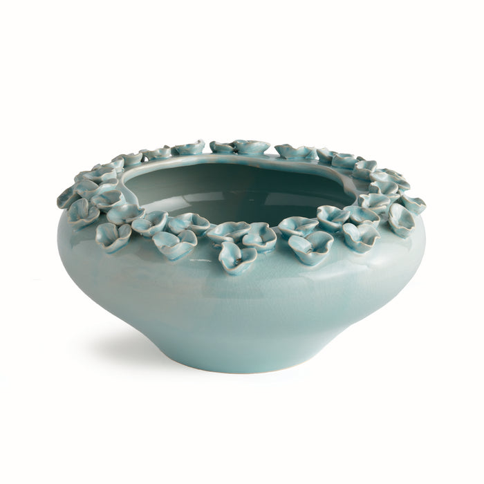 Light blue ceramic bowl with floral patterns on a white background