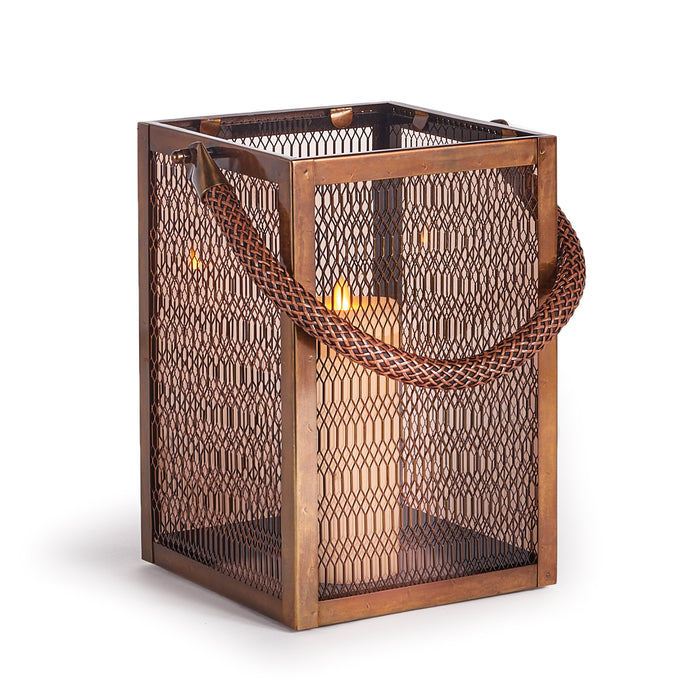A small metal lantern with a tinted glass front and a woven rope strap hanging from the top, designed to hold a candle.