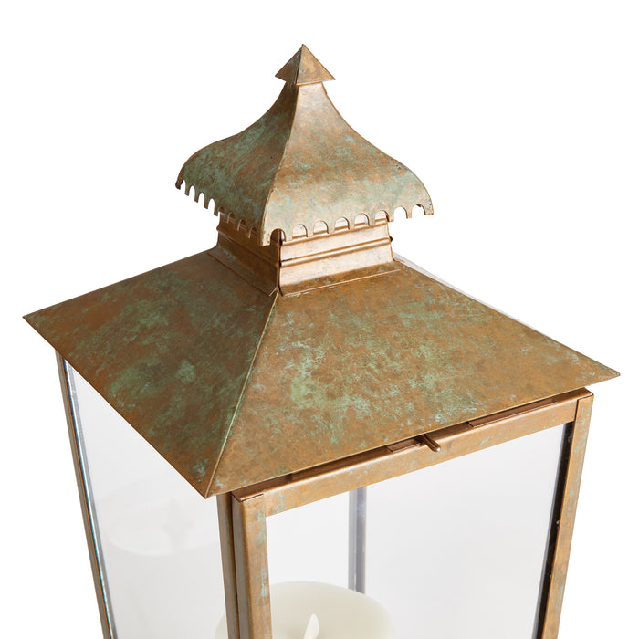 Large copper lantern with weathered patina, glass panels, and a decorative pagoda-style top against a white background.