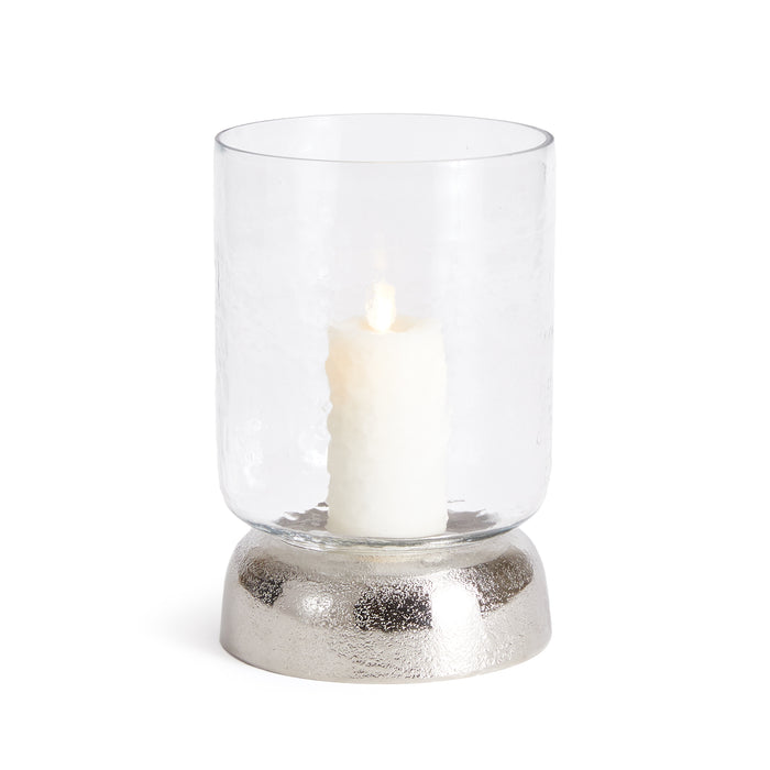 A clear glass hurricane with a chrome finish base, designed to hold a candle.